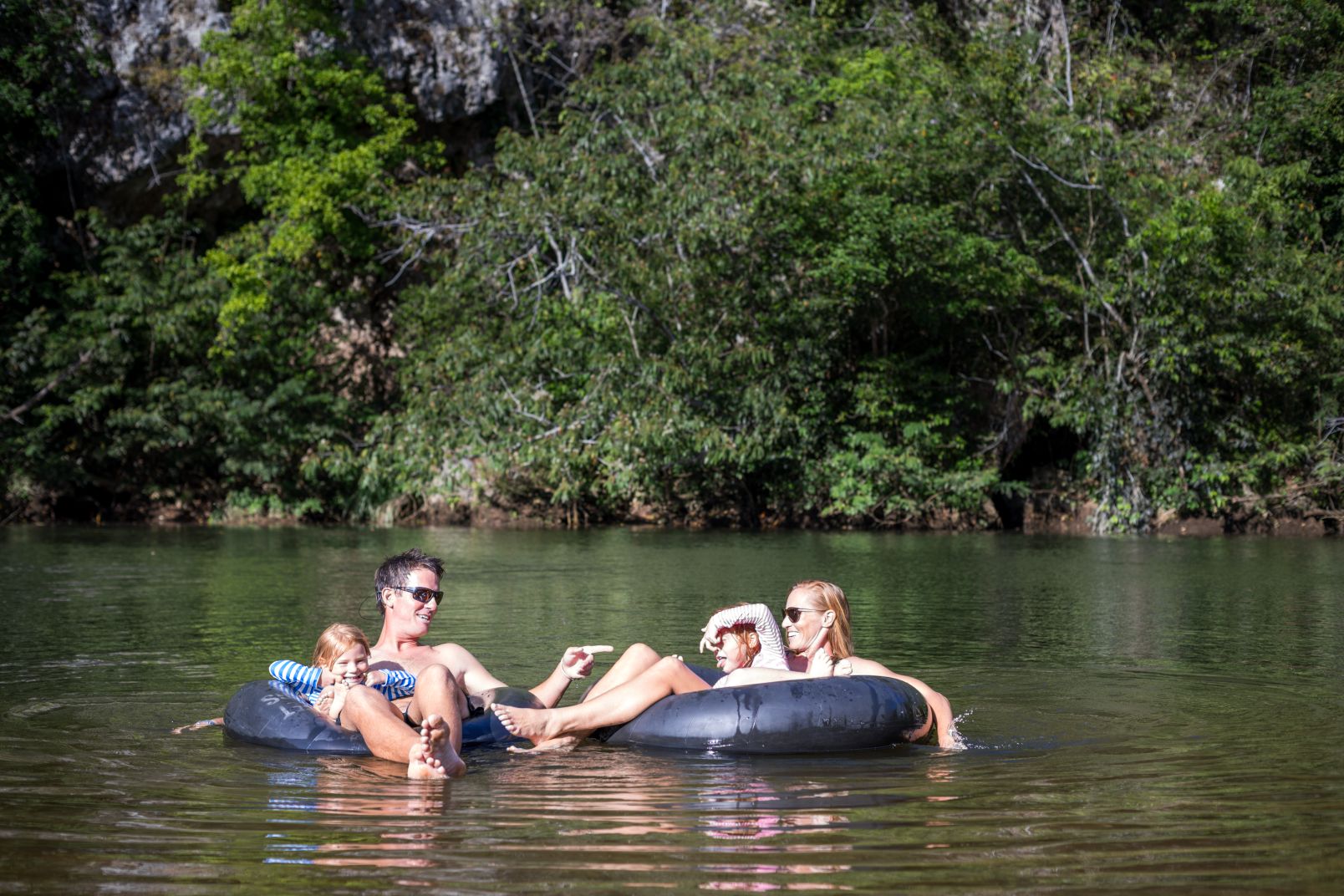 Family sitting on tubes