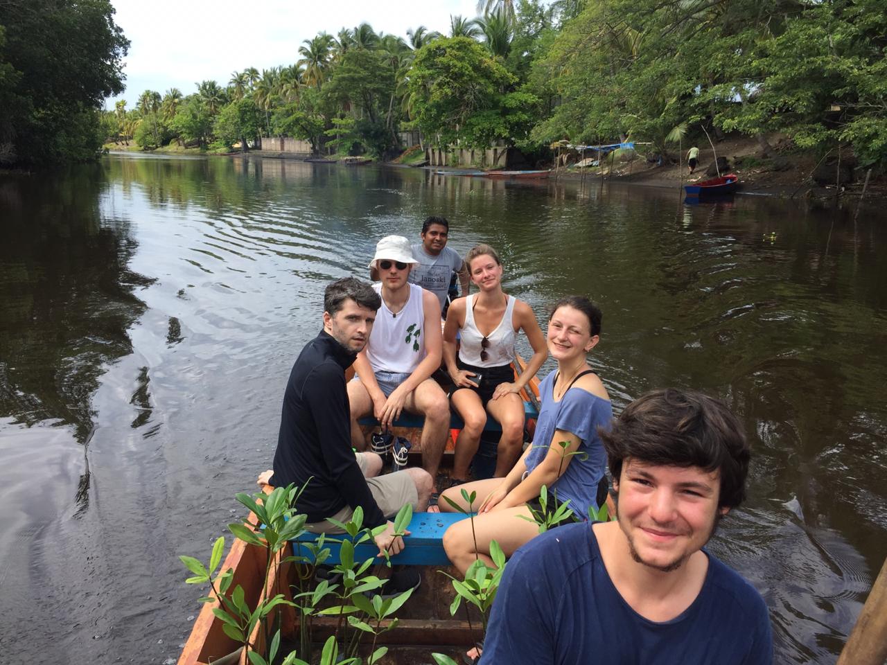 Volunteers on a canoe on the river