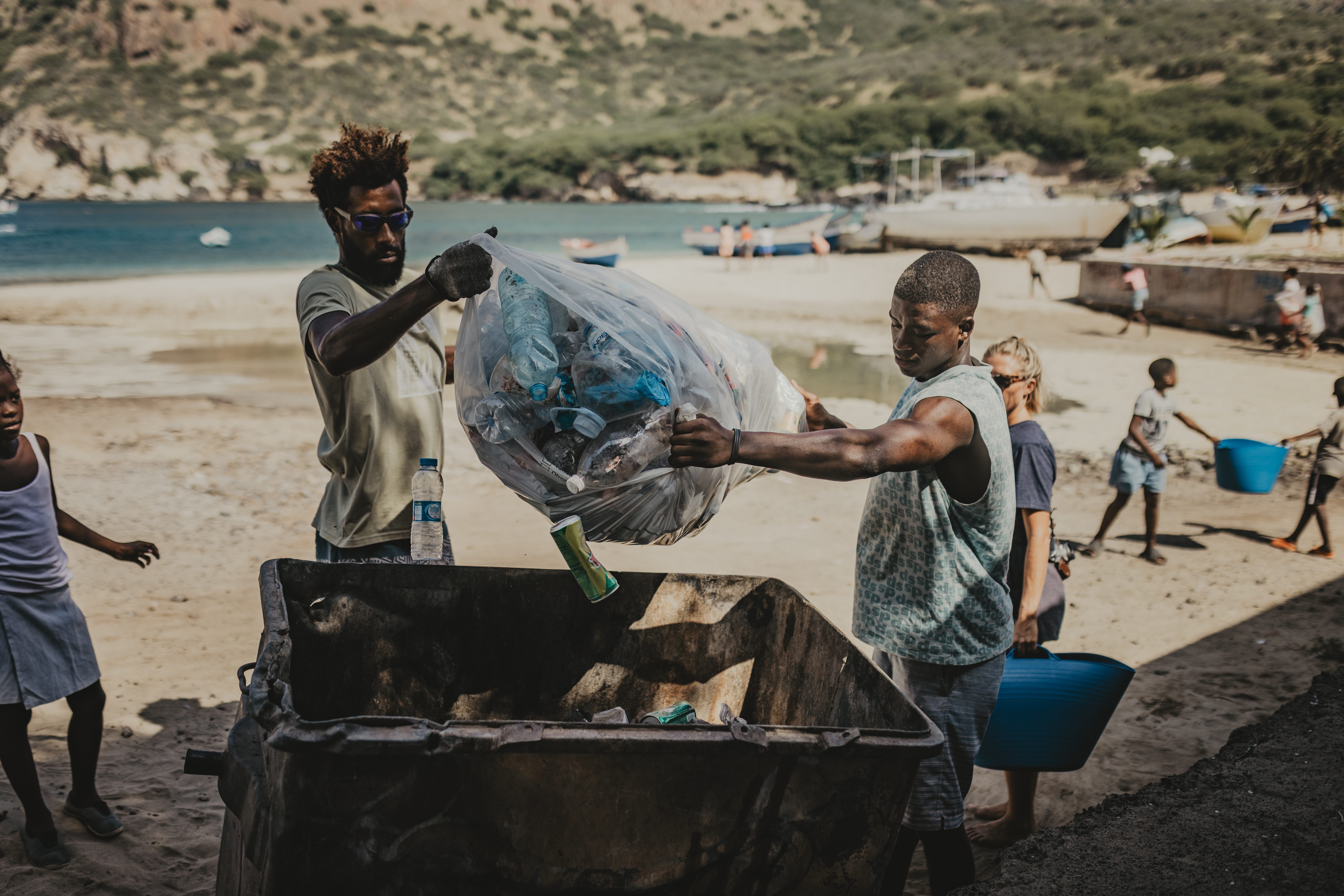 Volunteers throwing waste into bin