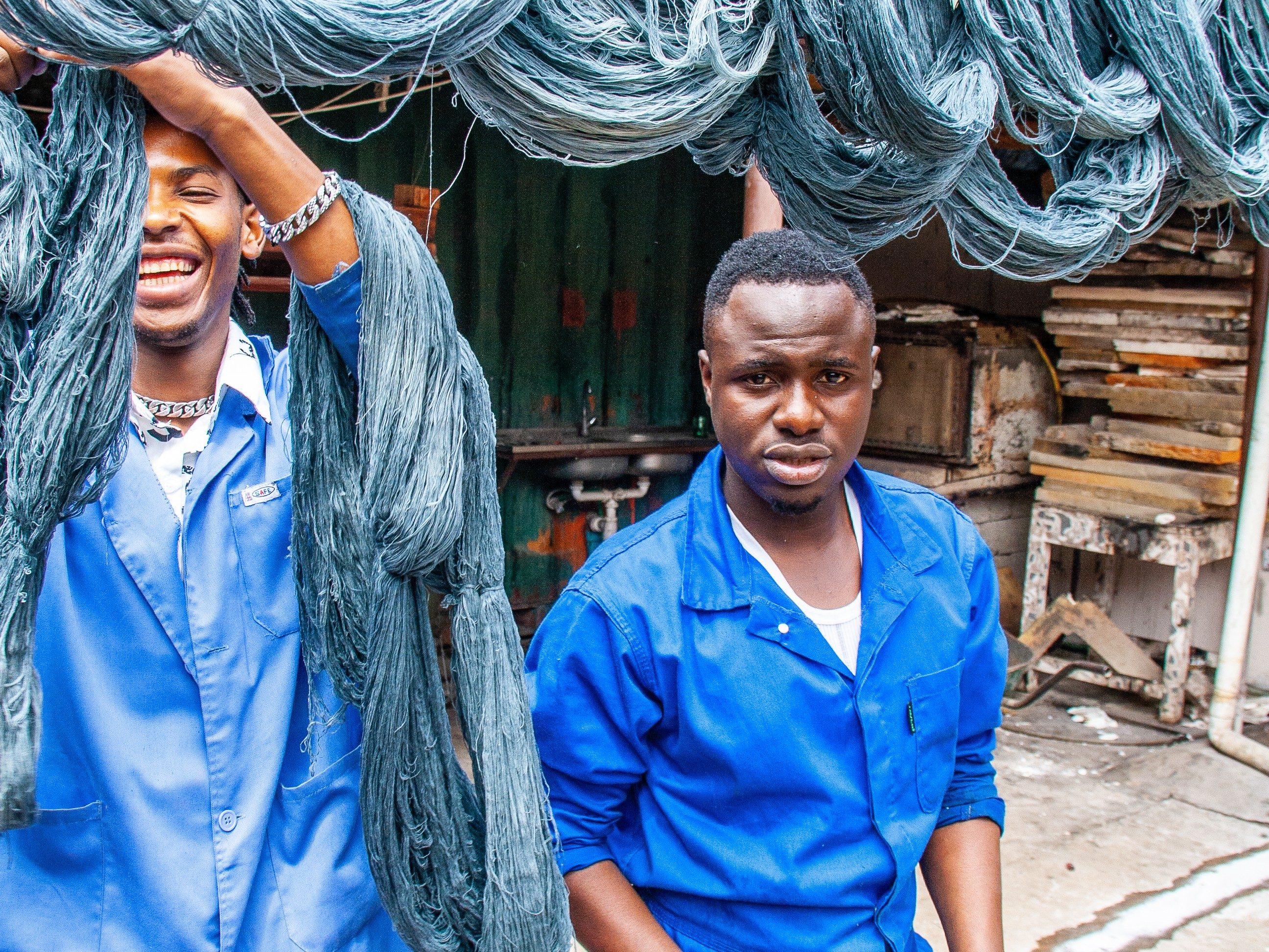 Photo of two employees laughing and hanging thread