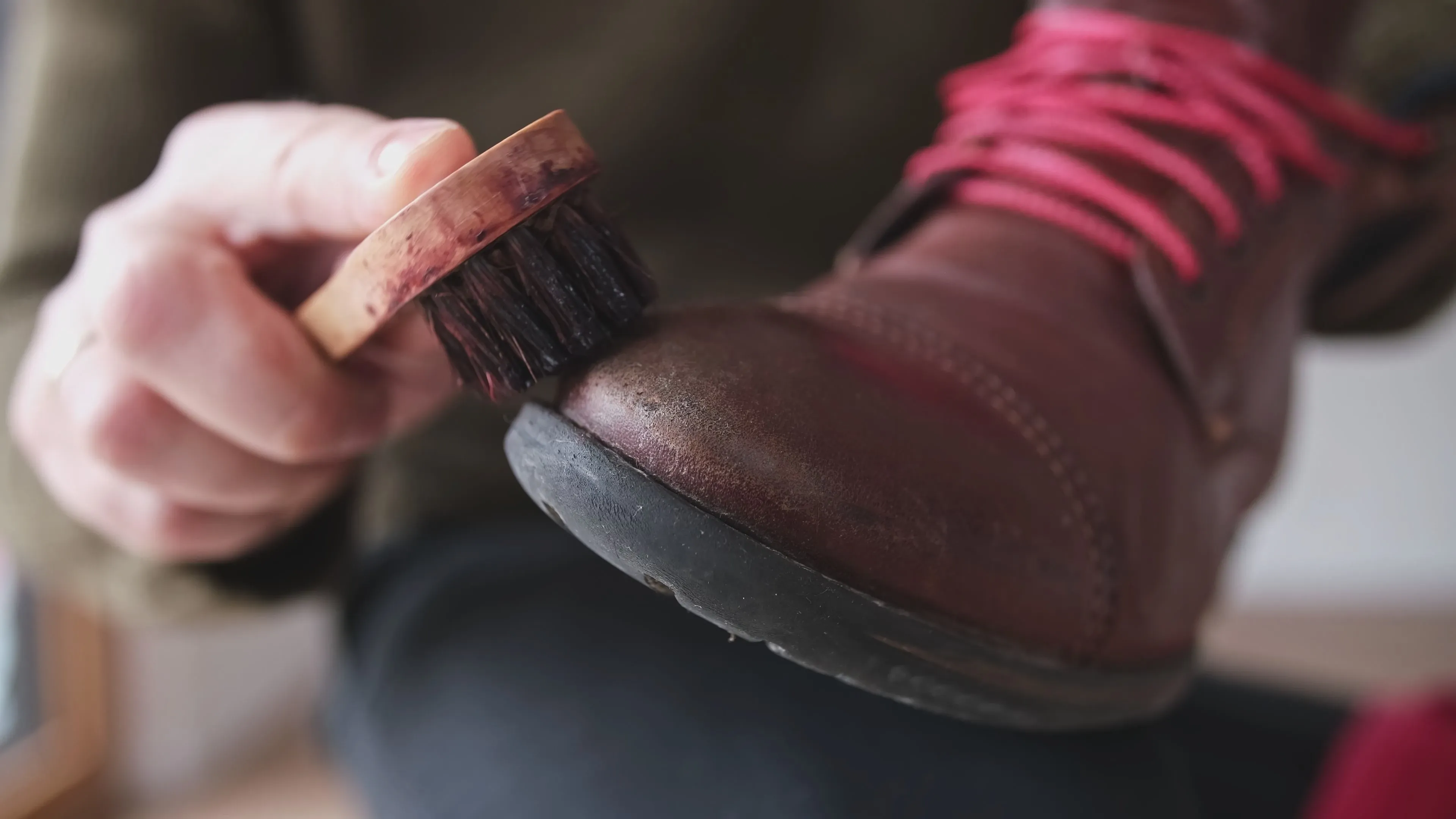 man cleaning shoes