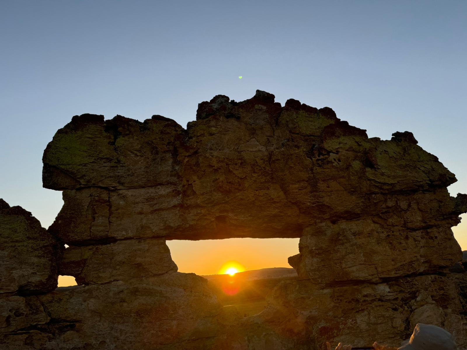 rock formation with sunray shining through
