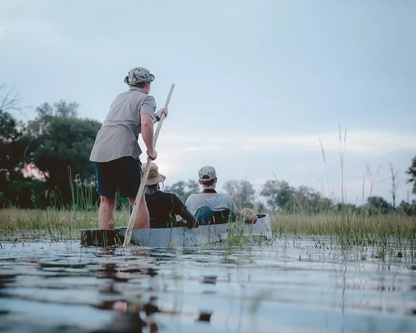 Three people in a mokoro