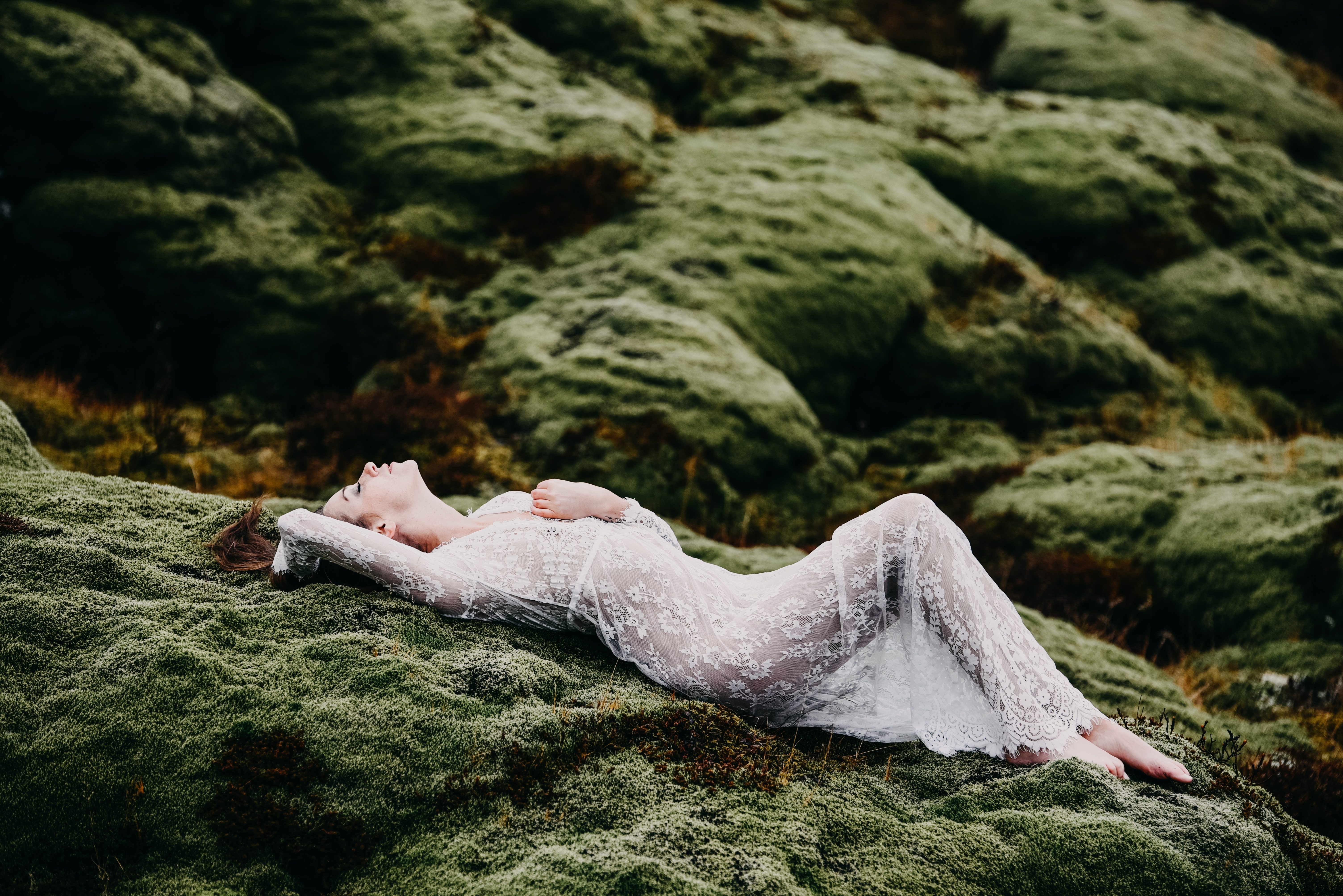 woman lying on moss in iceland