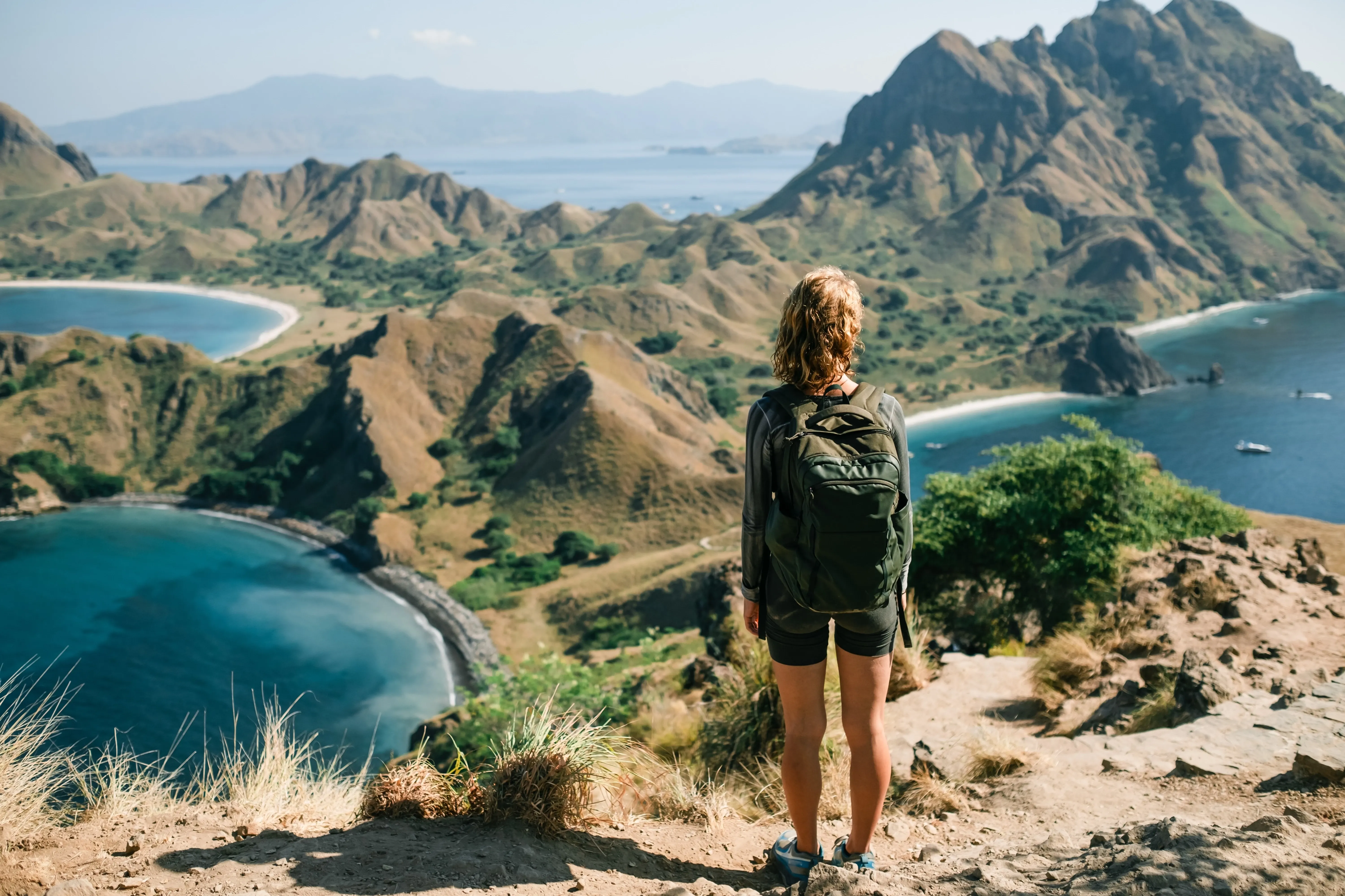 Woman with rucksack looking at island archipelago