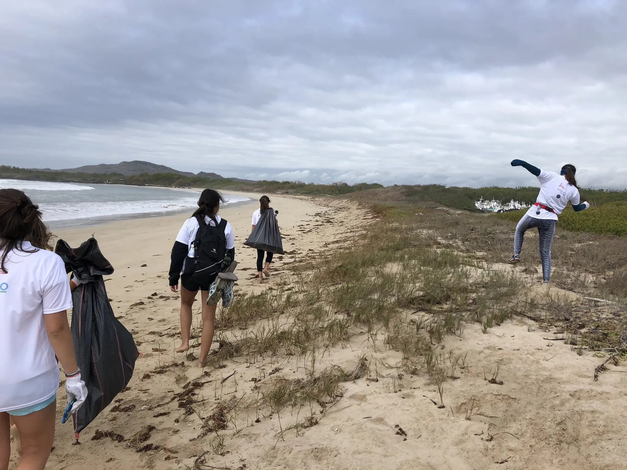 Freiwillige, die am Strand spazieren gehen und Müllsäcke für die Müllabfuhr haben