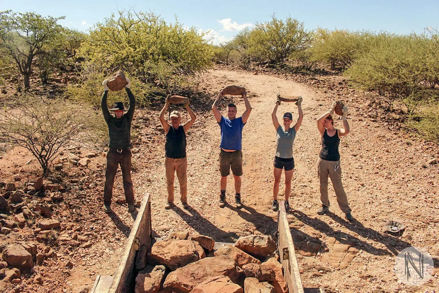 Volunteers holding bricks