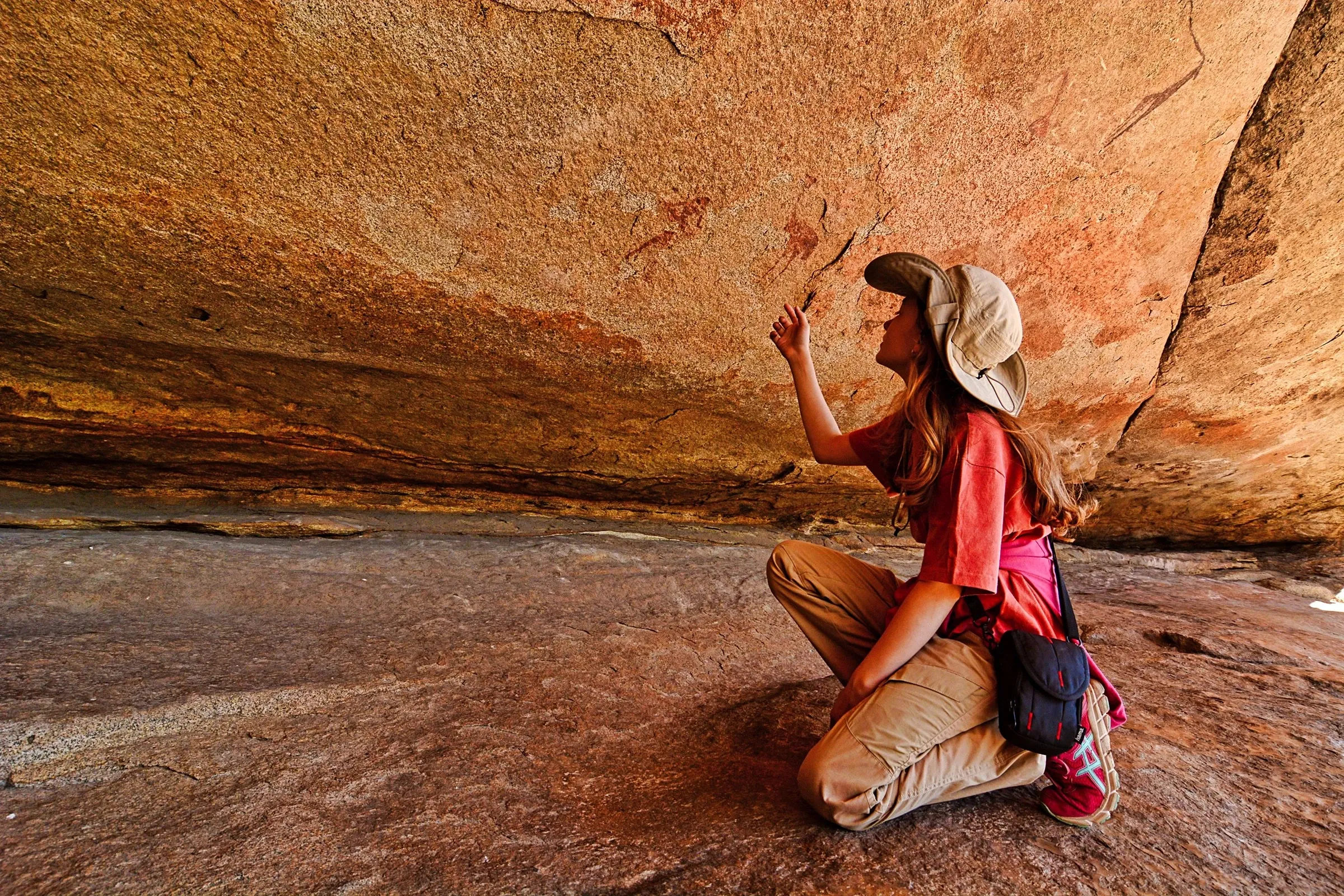 child looking at rock art in namibia