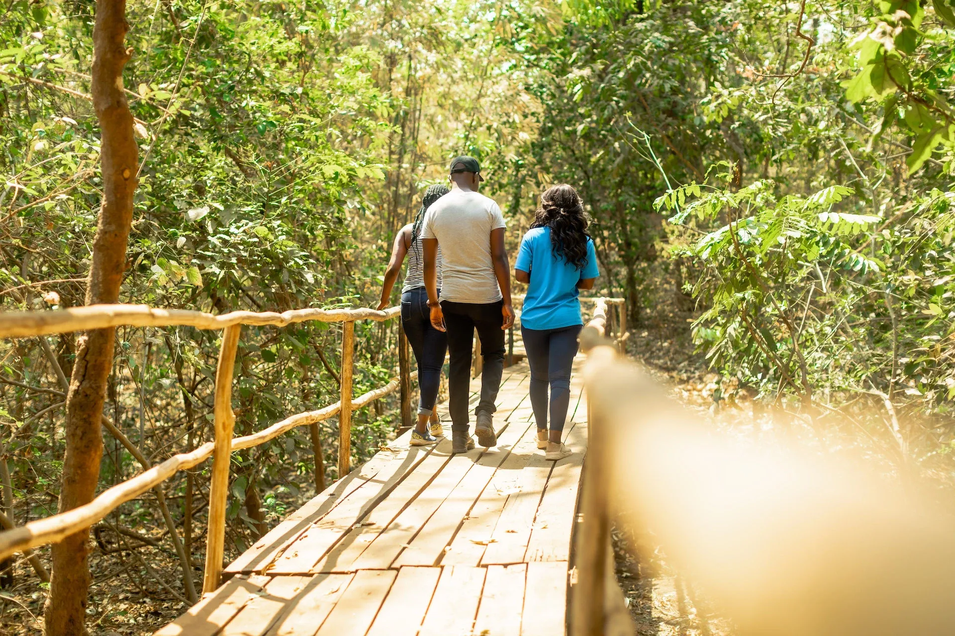 Volunteers walking on a wooden trail