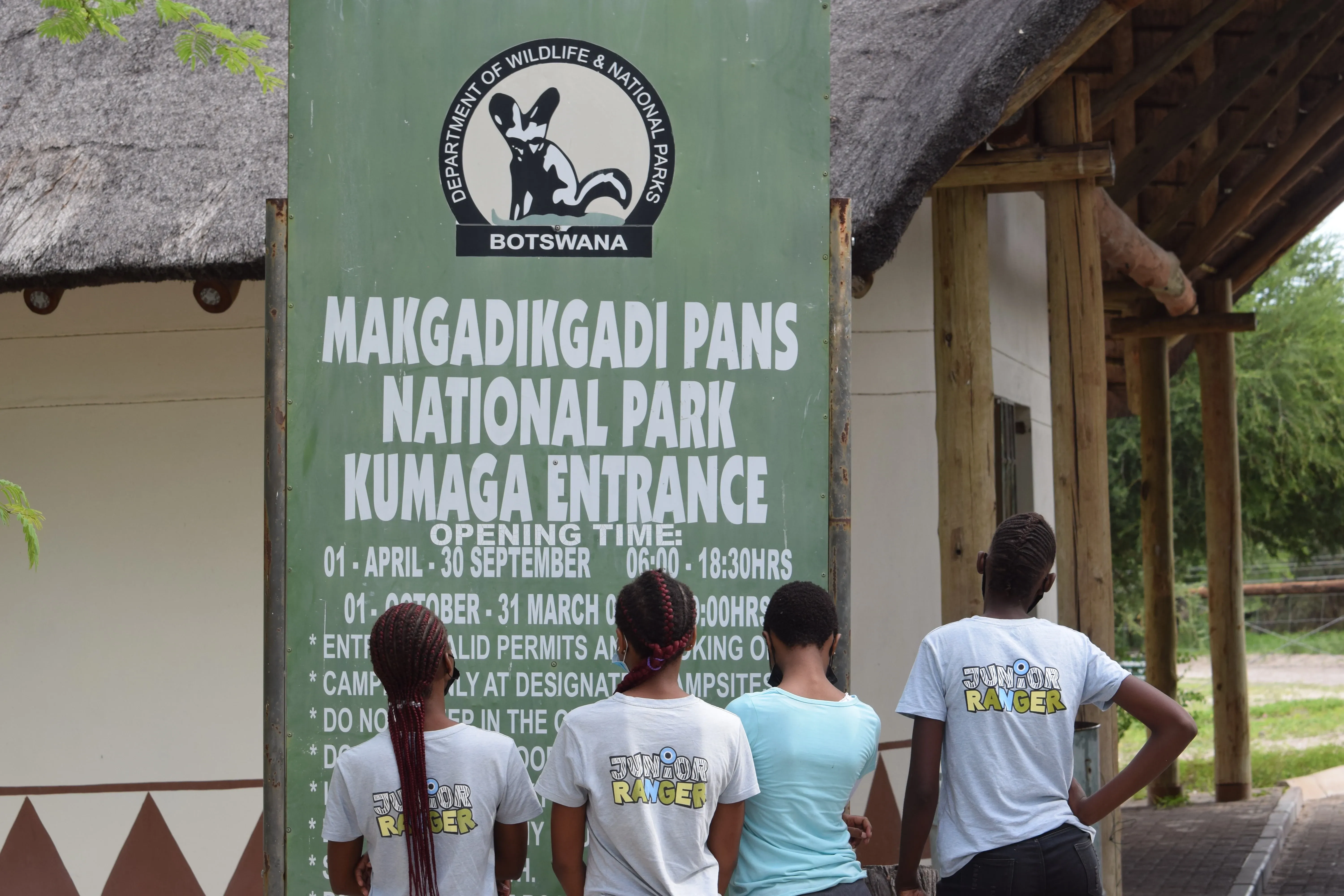 Botswana schoolchildren stand in front of Makgadikgadi poster