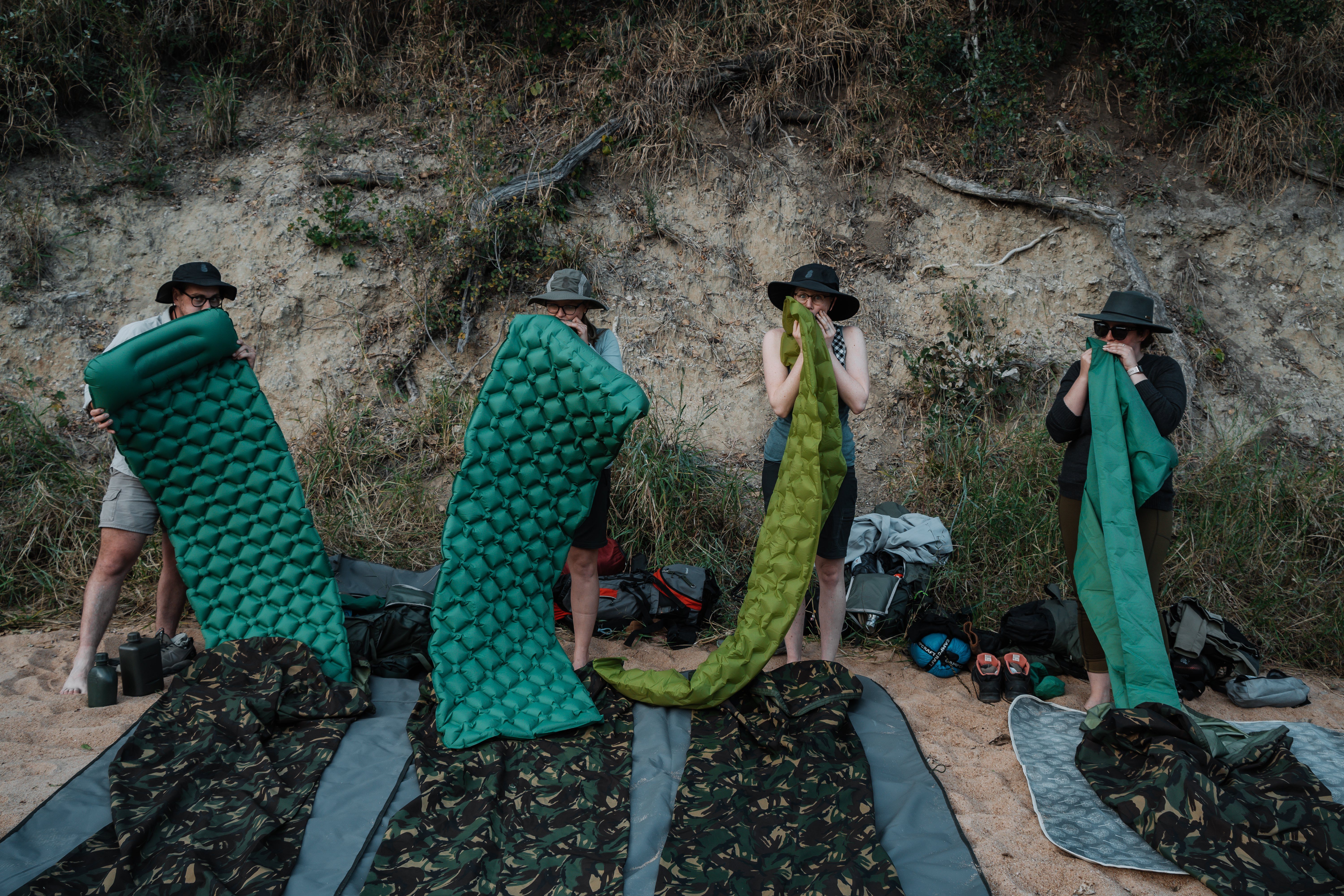 People inflate their air mattresses in the South African bush