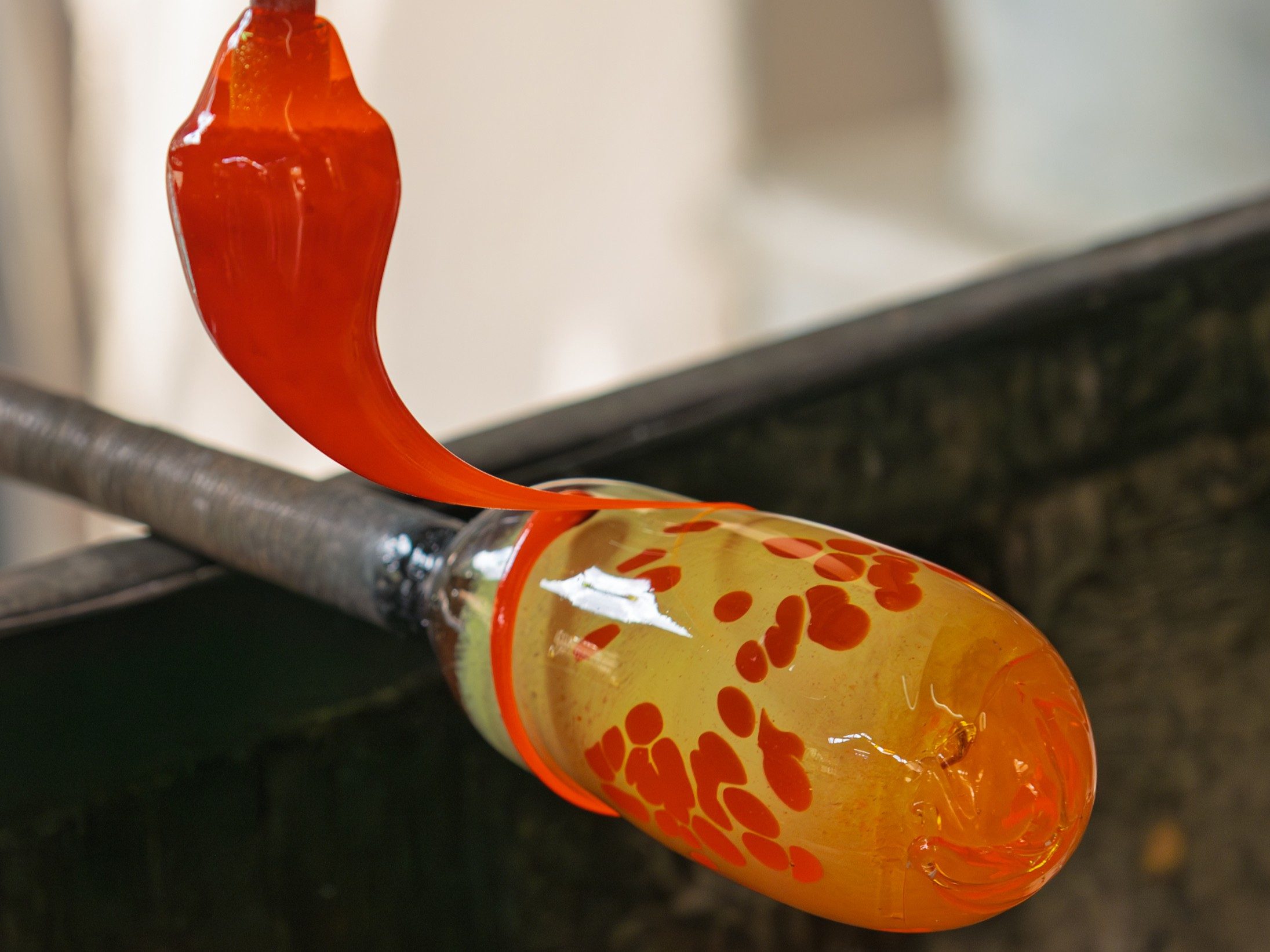 Adding designs to hot glass