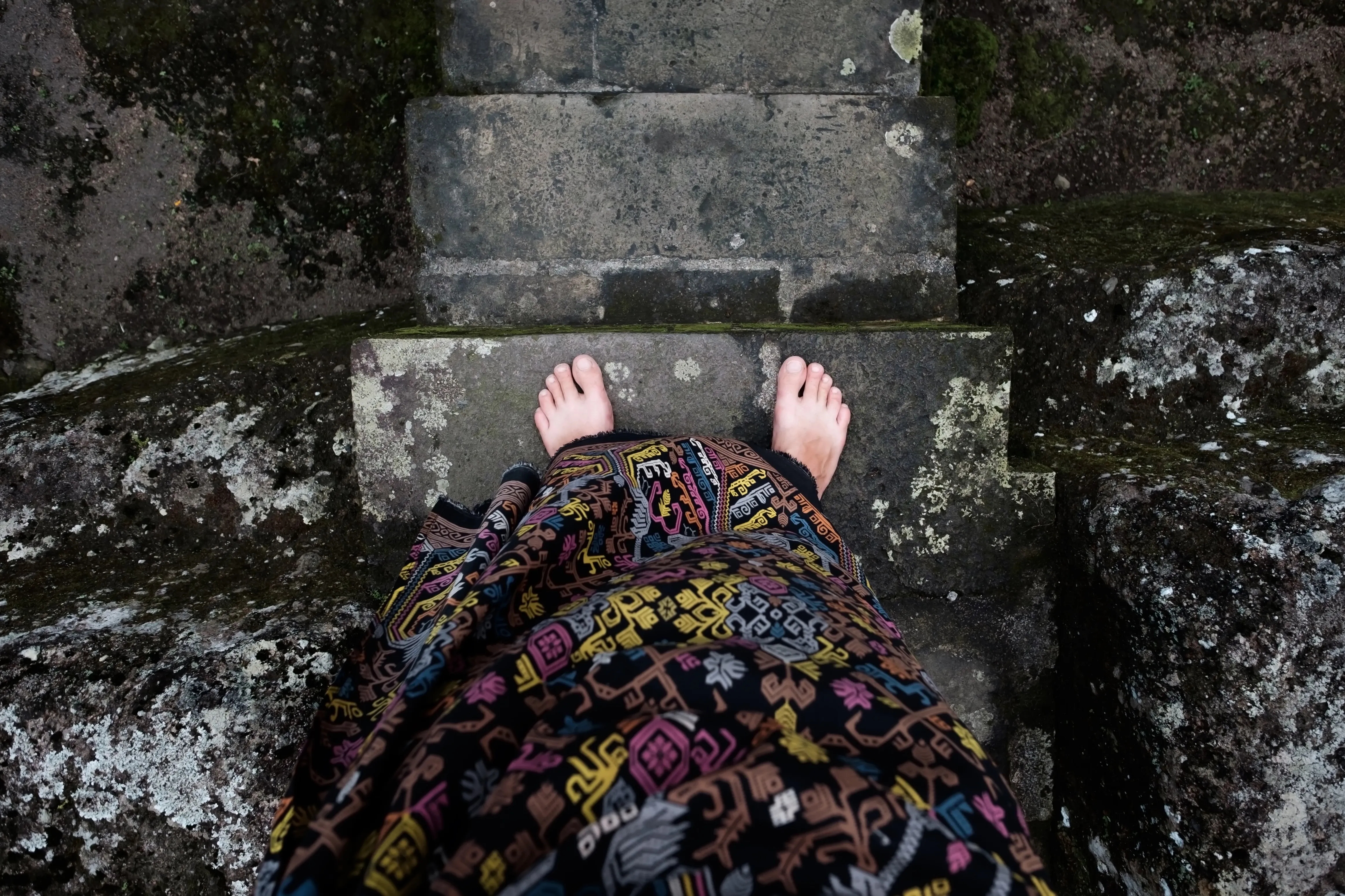 View of bare feet in front of temple